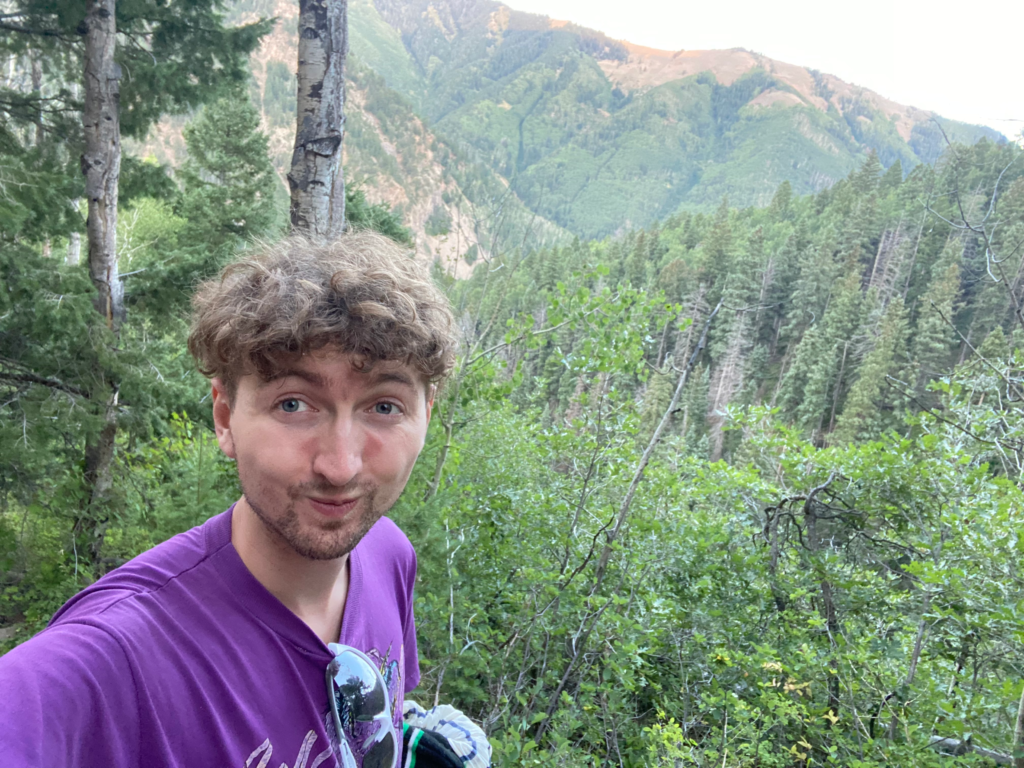 Picture of Ross Crow on a green mountain trail in Colorado.